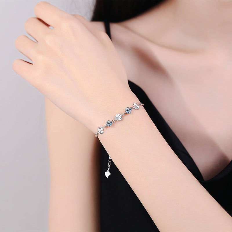 Four-leaf clover moissanite bracelet worn on wrist