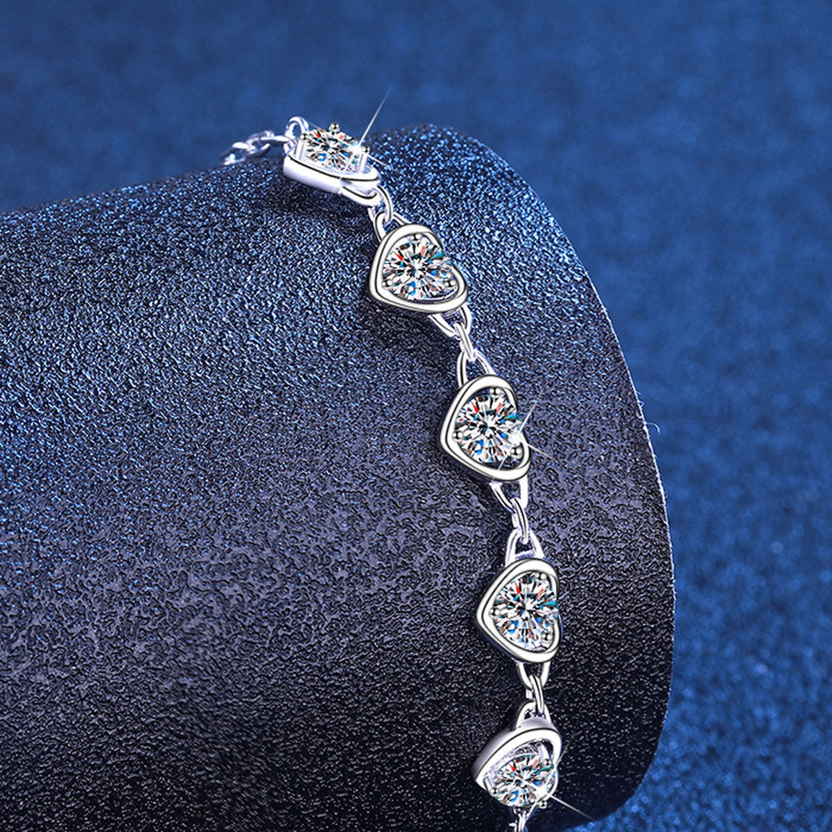 Five moissanite heart stations close-up