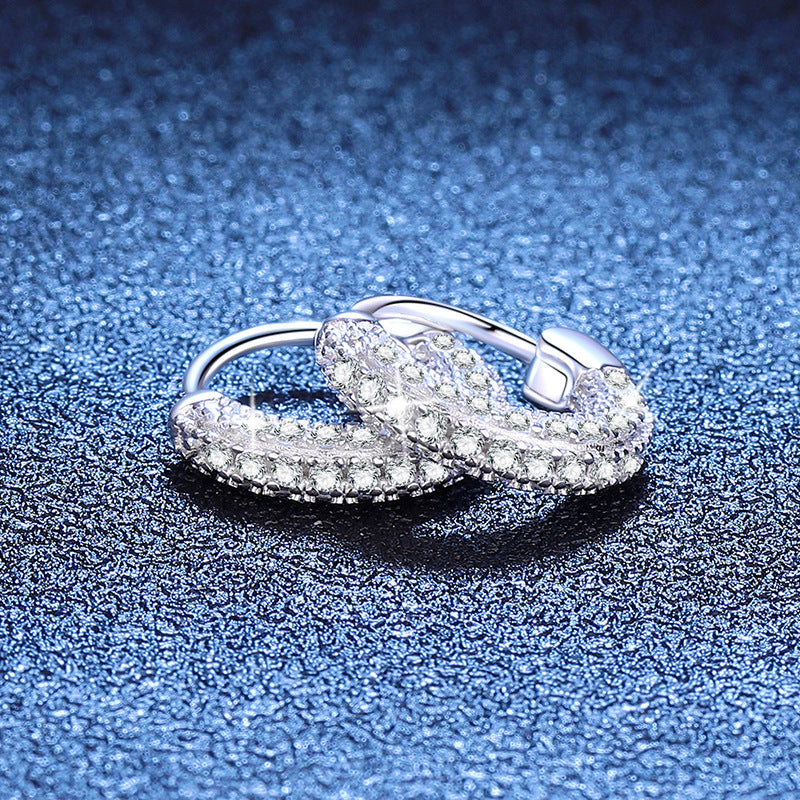 Close-up of micro-pavé moissanite huggies