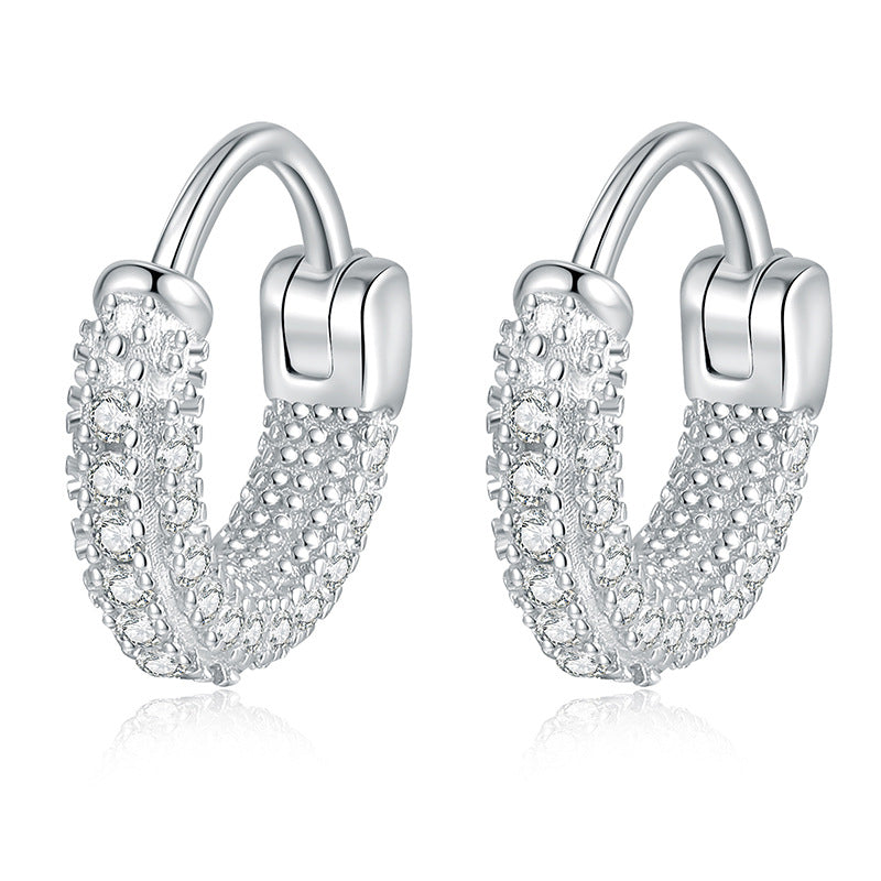 Pavé moissanite huggie earrings on white