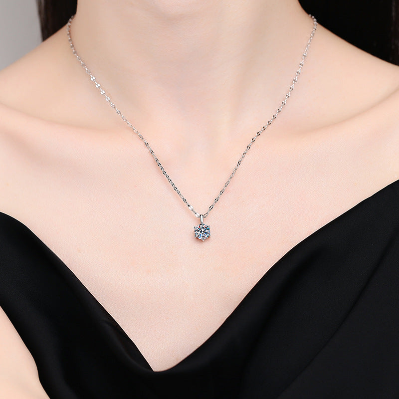 Model wearing the six-prong moissanite solitaire necklace in sterling silver