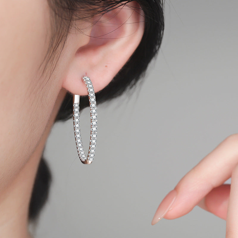 Pavé moissanite earrings in sterling silver — close-up of stones