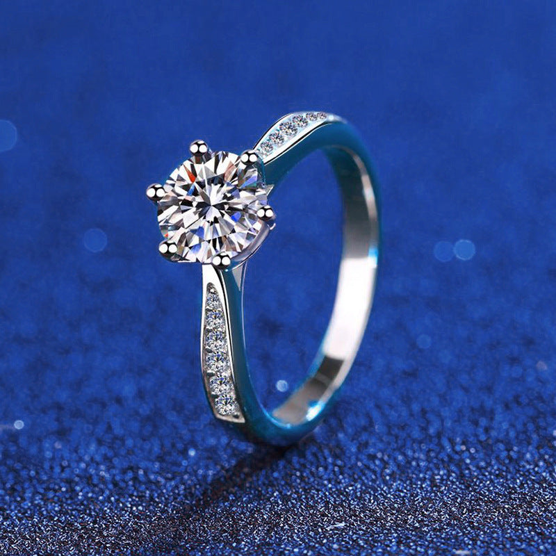 Six-prong moissanite solitaire ring with micro-pavé band in sterling silver