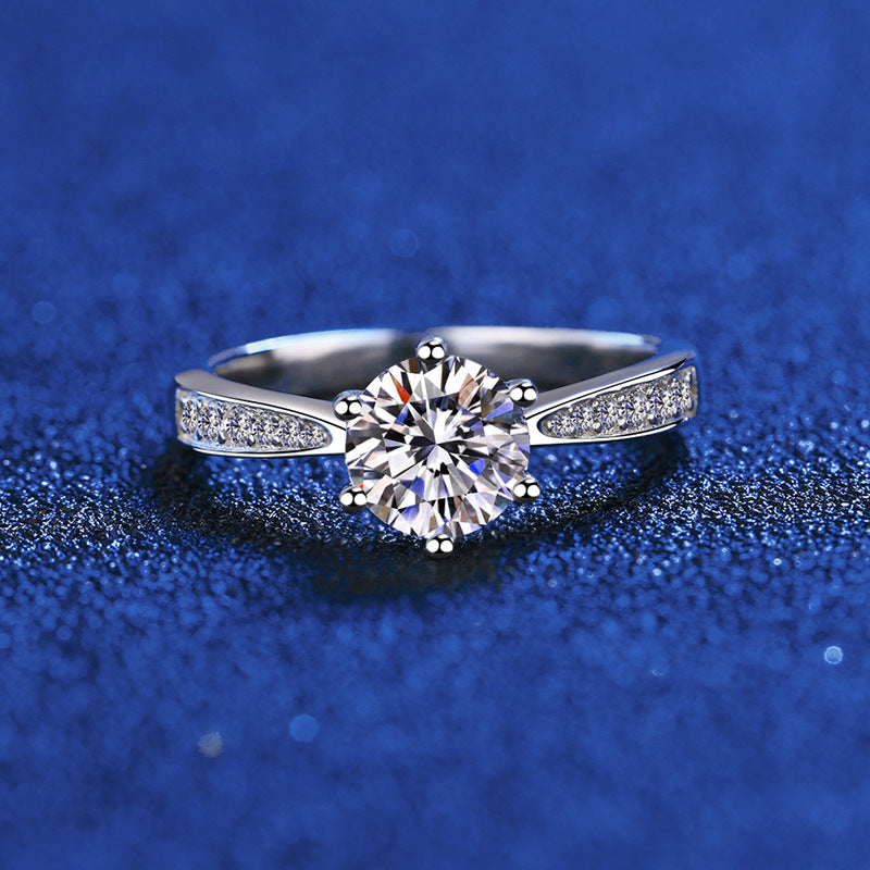 Six-prong moissanite solitaire ring with micro-pavé band in sterling silver